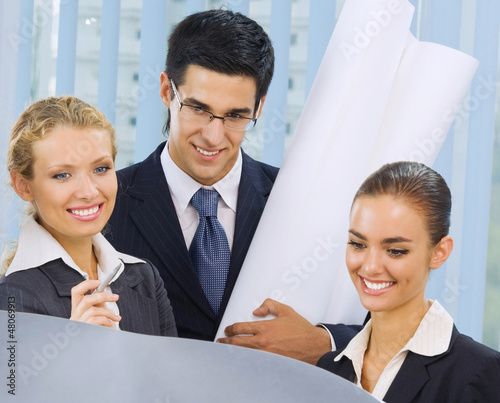 Photo: Businesspeople working at office Businesspeople working at office