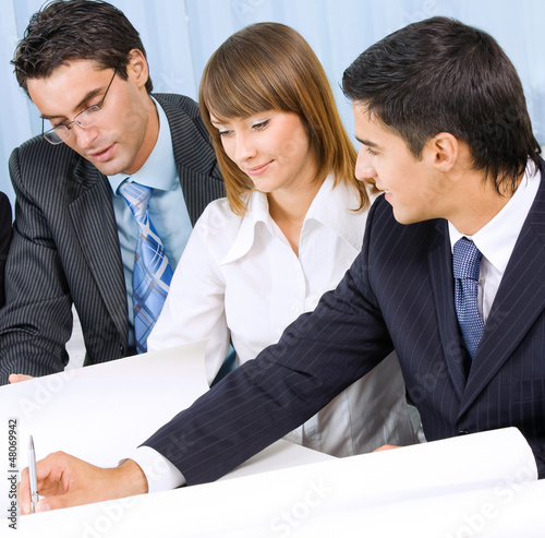 Photo: Three businesspeople working at office Three businesspeople working at office