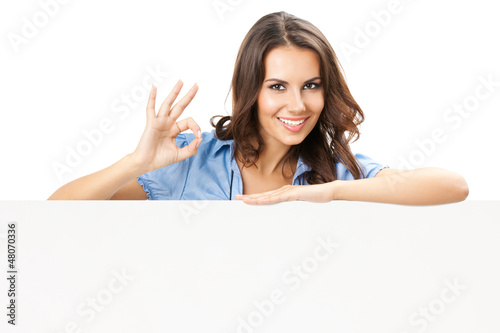 Photo: Beautiful young woman showing blank signboard Beautiful young woman showing blank signboard