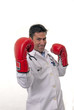Portrait of young doctor wearing boxing gloves.