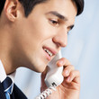 Portrait of young smiling businessman or call center worker
