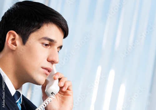 Photo: Portrait of young smiling businessman or call center worker Portrait of young smiling businessman or call center worker