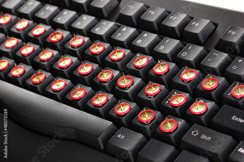 Photo: Painful typing, pins on keyboard close-up Painful typing, pins on keyboard close-up