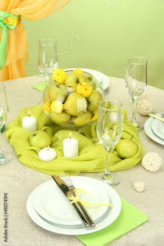 Photo: beautiful holiday table setting with apples, close up beautiful holiday table setting with apples, close up