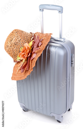 Photo: Silver suitcase with woman's hat isolated on white Silver suitcase with woman's hat isolated on white