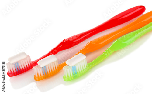 Photo: Toothbrushes and chewing gum isolated on white Toothbrushes and chewing gum isolated on white
