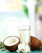 Coconut with glass of milk,  on blue wooden table