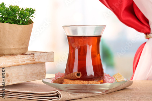 Photo: glass of Turkish tea and rahat lokum, on wooden table glass of Turkish tea and rahat lokum, on wooden table