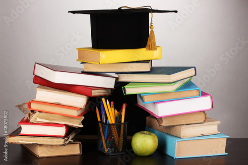 Photo: Books and magister cap against school board Books and magister cap against school board