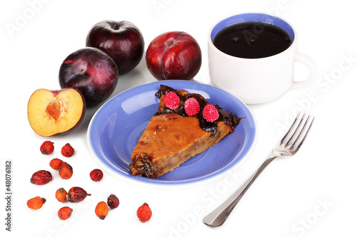 Photo: Tasty pie on blue plate with plums isolated on white Tasty pie on blue plate with plums isolated on white