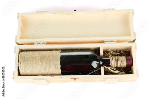 Photo: Wine bottle in wooden box, isolated on white Wine bottle in wooden box, isolated on white