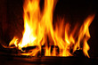 Photo: Fire in a fireplace. Fire flames on a black background Fire in a fireplace. Fire flames on a black background