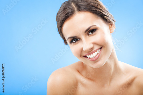 Photo: Portrait of beautiful woman, on blue Portrait of beautiful woman, on blue
