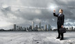 Businessman with colourful light beam in his hands