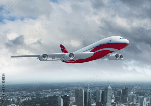 Photo: White passenger plane flying above a city White passenger plane flying above a city