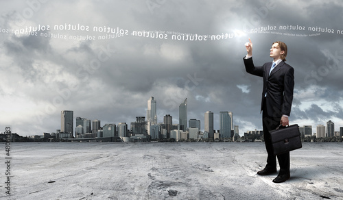 Photo: Businessman with colourful light beam in his hands Businessman with colourful light beam in his hands