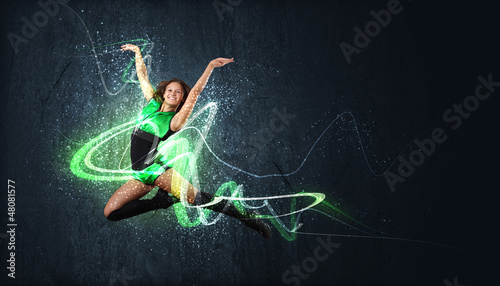 Photo: Young woman dancer. With lights effect. Young woman dancer. With lights effect.