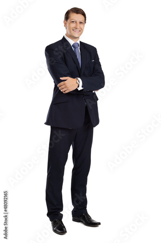 Photo: Attractive businessman standing with arms crossed Attractive businessman standing with arms crossed