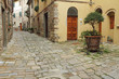 narrow italian street and small patio in tuscan village