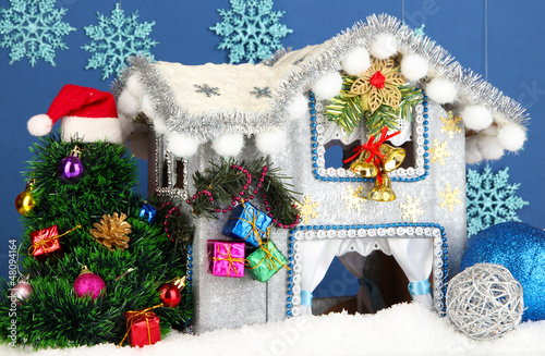 Photo: Decorated Christmas house on blue background Decorated Christmas house on blue background