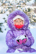 Cheerful little girl playing in a snowy forest