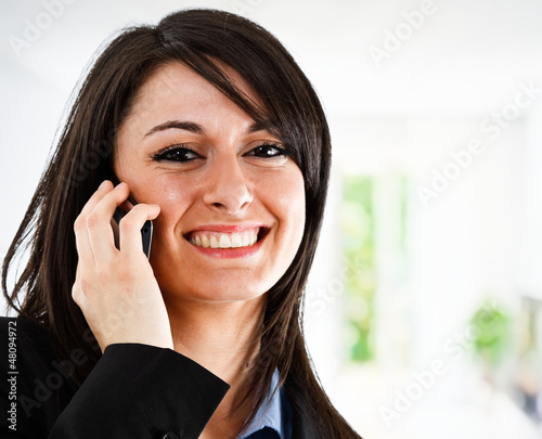 Photo: Smiling businesswoman talking on the phone Smiling businesswoman talking on the phone