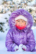 Cheerful little girl playing in a snowy forest