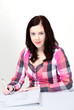 Photo: Young woman writing notes Young woman writing notes