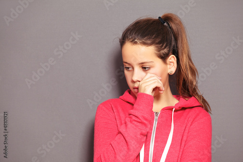Photo: Sad little girl wiping away tears Sad little girl wiping away tears