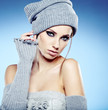 beautiful woman in warm clothing on blue background