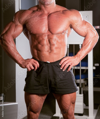 Photo: bodybuilder posing in the gym bodybuilder posing in the gym