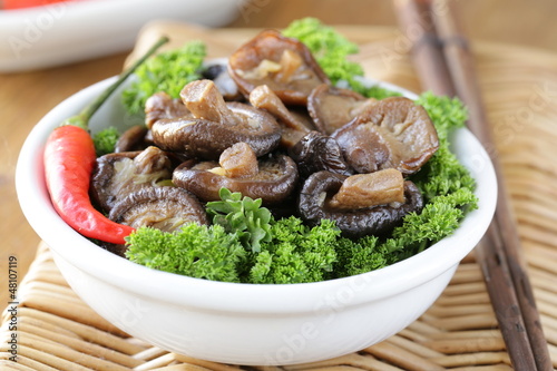 Photo: Chinese fried shiitake mushrooms in a bowl with parsley Chinese fried shiitake mushrooms in a bowl with parsley