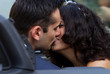 Happy newlyweds kissing in cabrio