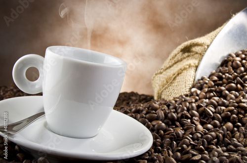 Photo: Coffee smoking on the coffee beans background Coffee smoking on the coffee beans background