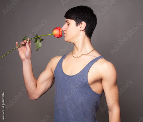 Photo: muscular man with a rose in hands muscular man with a rose in hands