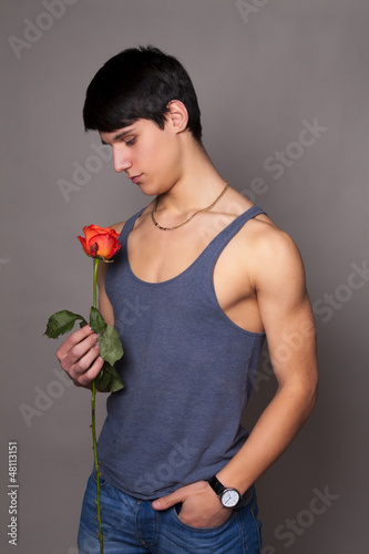 Photo: muscular man with a rose in hands muscular man with a rose in hands