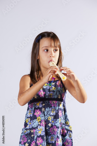 Photo: Little girl playing flute Little girl playing flute