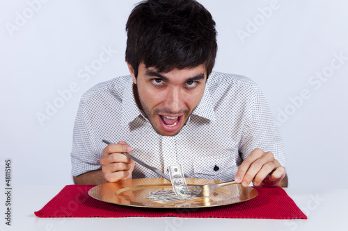 Photo: Man eating little dollar banknote Man eating little dollar banknote