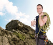 rock climber with equipment including rope, harness and helmet