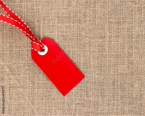 Photo: red label with ribbon on burlap red label with ribbon on burlap