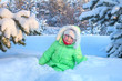 Little girl walking in the snowy woods.
