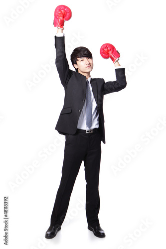 Photo: Businessman win pose with boxing gloves Businessman win pose with boxing gloves