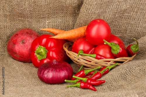 Photo: fresh red vegetables on sackcloth background fresh red vegetables on sackcloth background