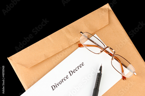 Photo: Divorce decree and envelope on black background Divorce decree and envelope on black background