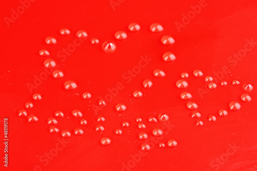 Photo: Water drops on red background Water drops on red background