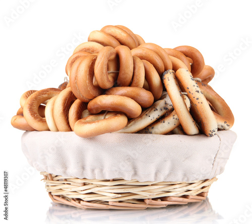 Photo: tasty bagels in basket, isolated on white tasty bagels in basket, isolated on white