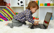 cute little boy and notebook in room