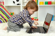 cute little boy and notebook in room