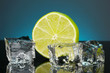 Ice cubes with lime on darck blue background