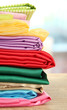 heap of cloth fabrics on wooden table